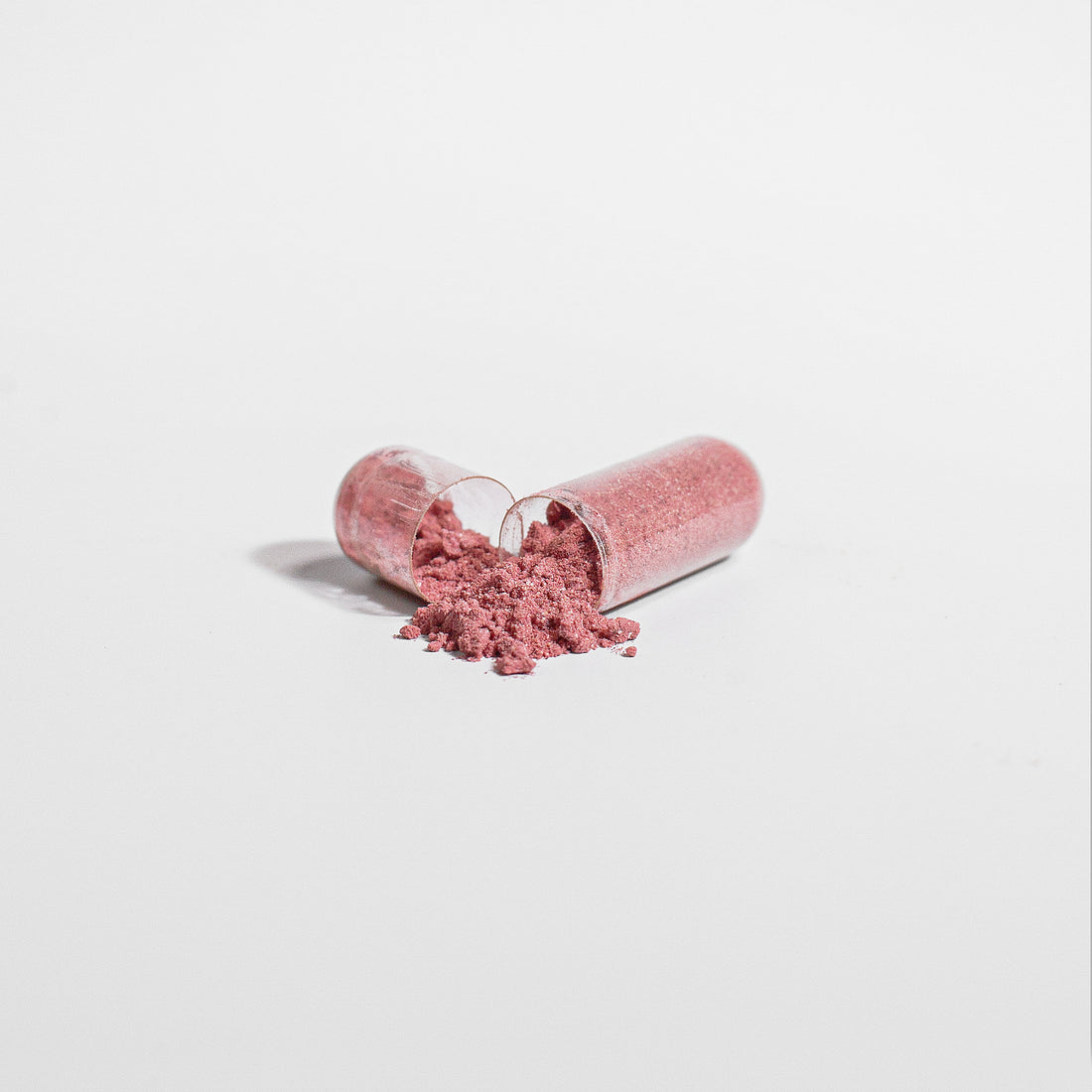 Pink powder in an open cylindrical image